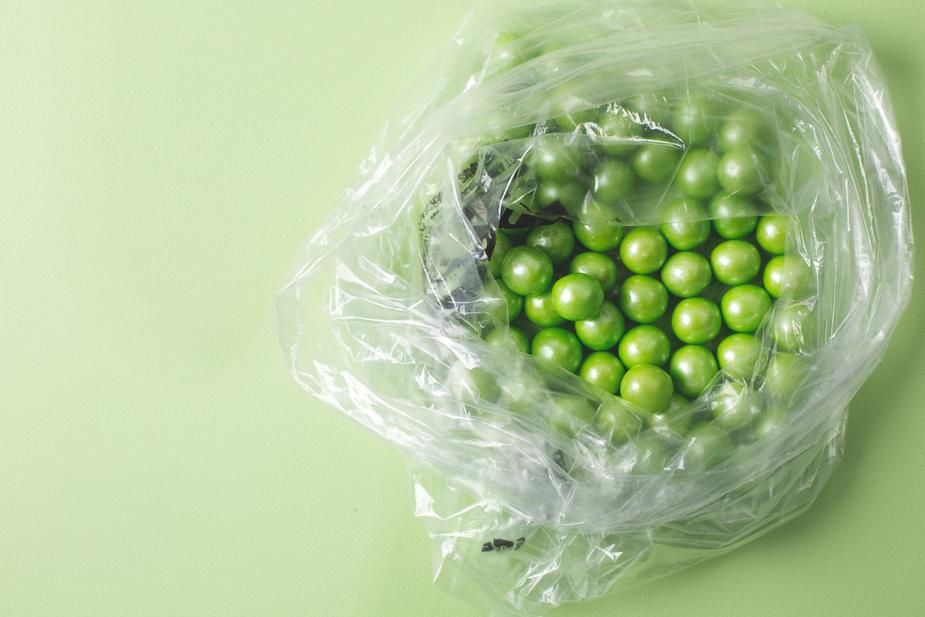 Green round candies inside a plastic bag.